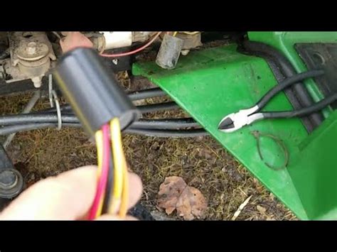 The loader has a large bucket attached. . John deere 425 time delay module bypass